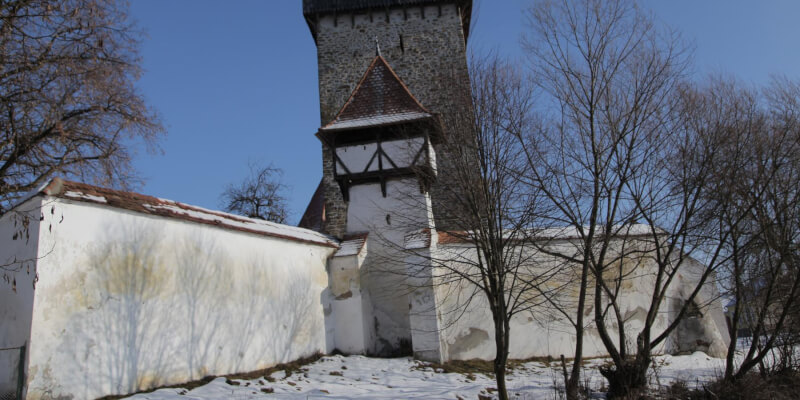 Circumferential wall with a small defense tower in the fortified church in Stejarisu.
