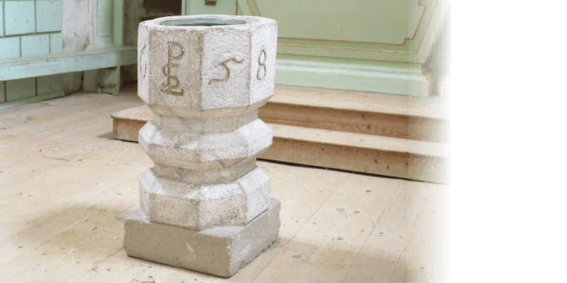 The baptismal font in the fortified church in Bunesti in Transylvania